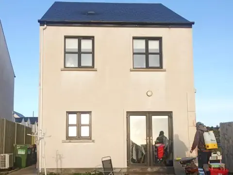 Exterior walls of a house after being washed, removing red algae