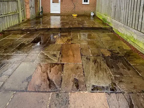 Before image of a Sandstone patio professionally cleaned in Waterford